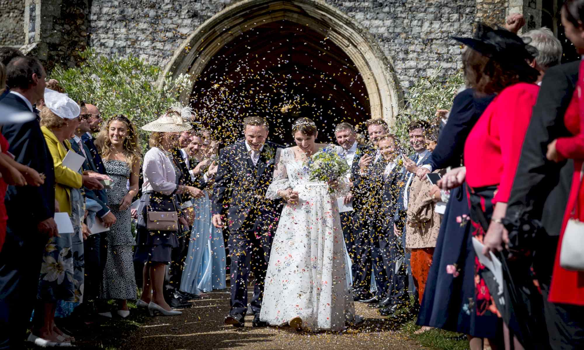 Top Locations for Wedding Photography in Norfolk and Suffolk Bride and Groom leaving Church with confetti being thrown